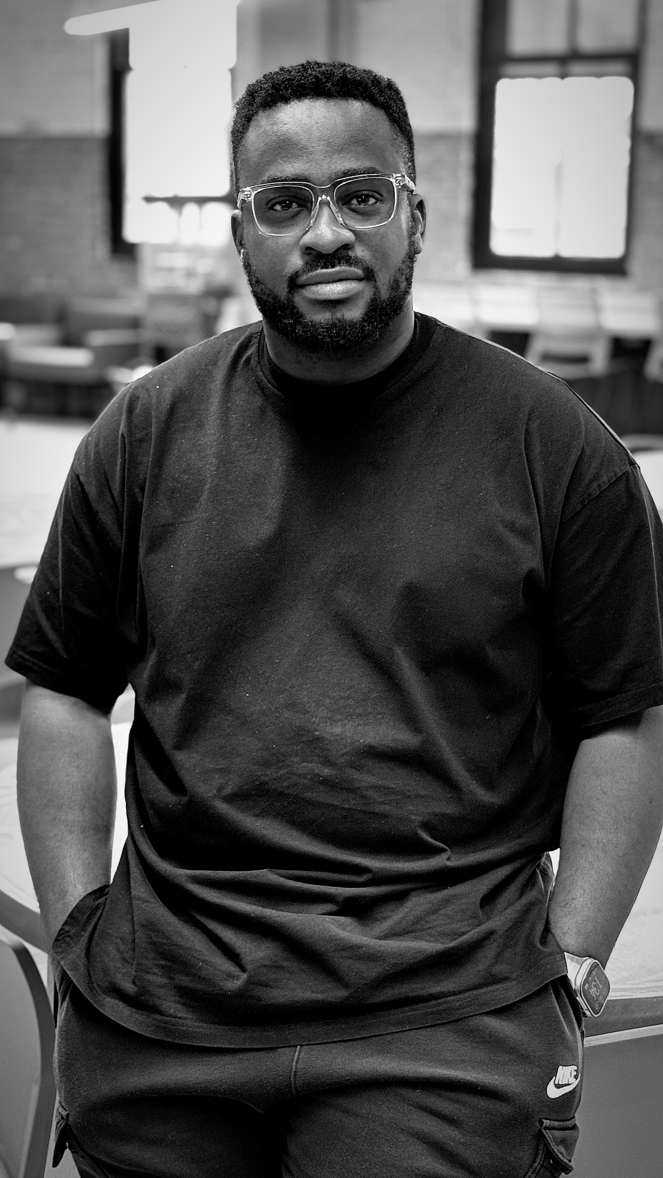 A professional headshot of Salem Smith in black and white